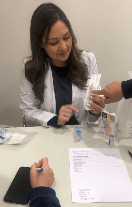 Fertility nurse showing IVF medication and drug